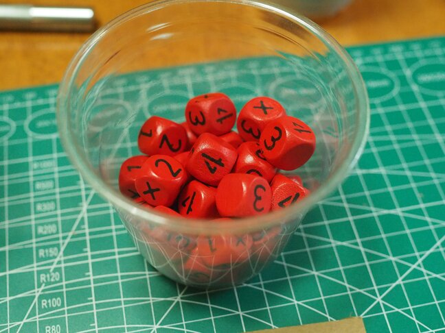 A cup of fully painted dice.